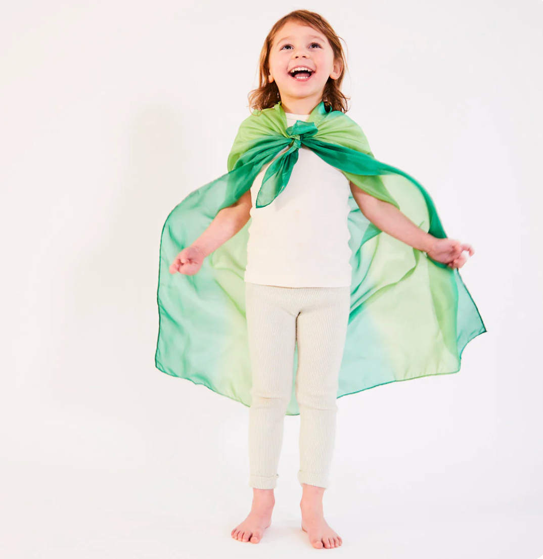 A child wears a playsilk as a cape The Doodle Post
